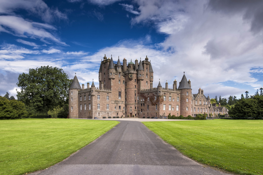 Glamis, United Kingdom - August 17,2014: View of Glamis Castle in Scotland, United Kingdom. Glamis Castle is situated beside the village of Glamis in Angus. It is the home of the Countess of Strathmore and Kinghorne, and is open to public.